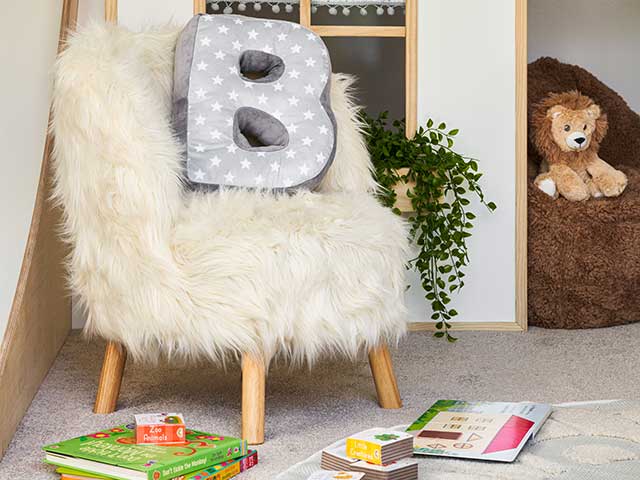Fluffy chair with B cushion and scattered books
