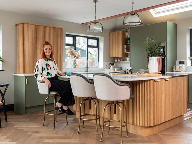 interior designer Emily Robson sitting in her newly renovated open-plan kitchen-diner