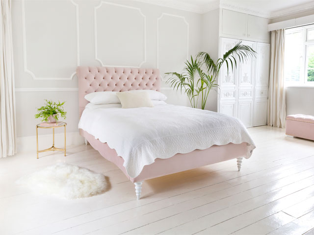 french regency style bedroom with a modern twist - grey walls, pink bed and palm plants