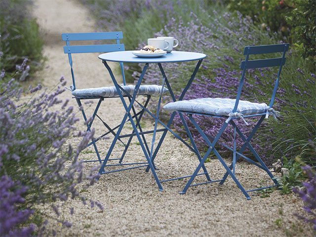 Bistro garden dining set on stones with lavender overgrown beside