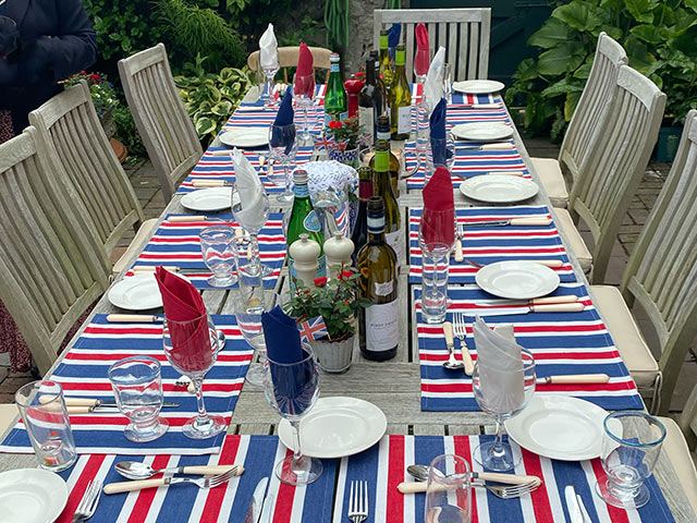 Coronation tablescape at coronation themed party with red white and blue striped decor