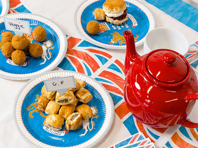 Coronation themed party coronation tablescape with union jack napkins and recyclable paper plates
