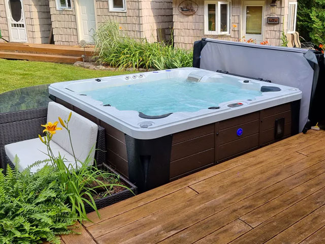 6-person ex-display hot tub in a large garden canadian spa company