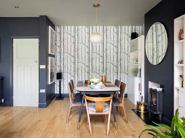 zoned kitchen dining space with panelled walls and wooden floor