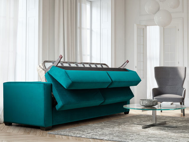 Teal sofa bed with deep mattress and steel frame unfolding in living room