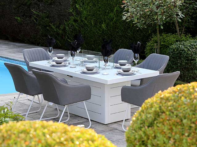 six seater garden dining sets with built in firepit beside pool