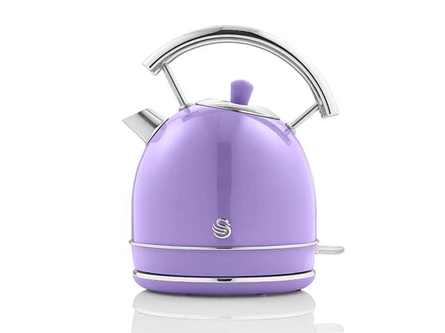 retro purple kettle on white background with silver spout and handle