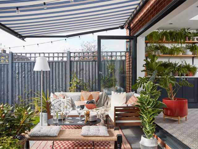 outdoor living with an awning sheltering the outdoor dining area