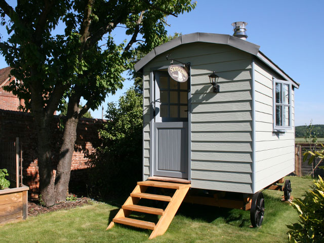 blue/grey shepherd's hut with grey fibre cement facades