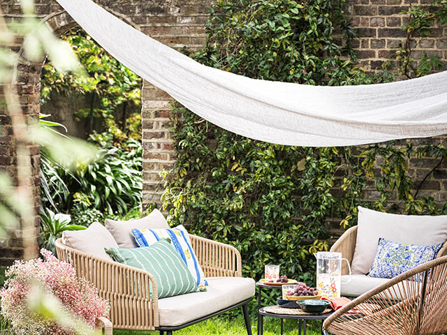 shade canopy over wicker furniture in garden