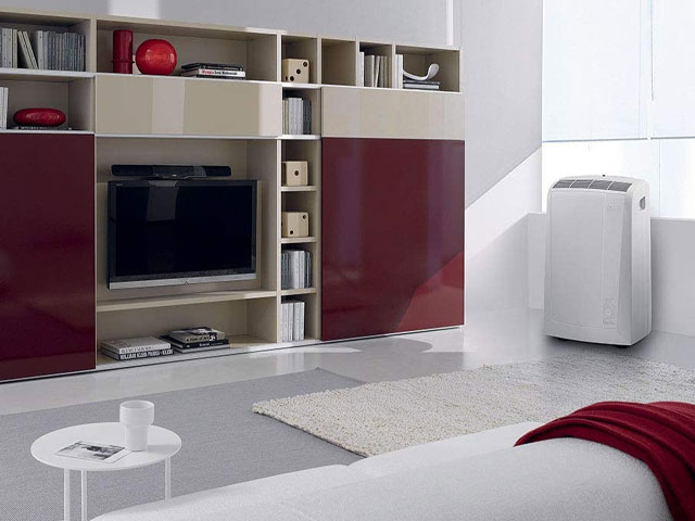 delonghi portable air conditioning unit in a medium sized living room with media wall and modern decor