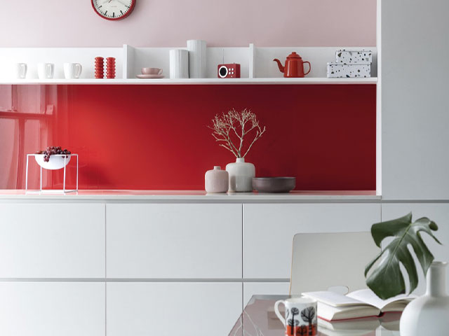 red kitchen splashback with pink painted walls and white cabinets