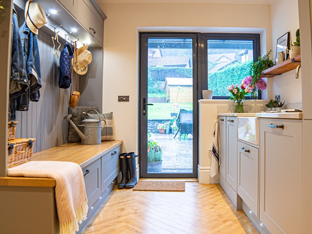 boot room with sink, storage bench and space to hang coats