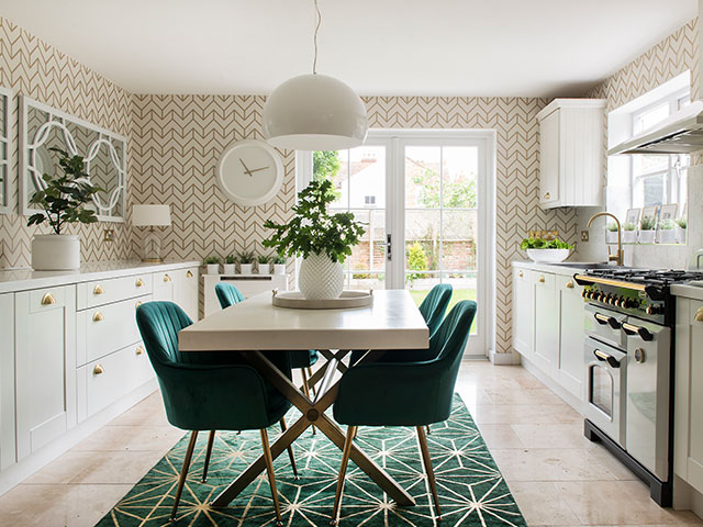 The kitchen's pale colour scheme has rich green highlights