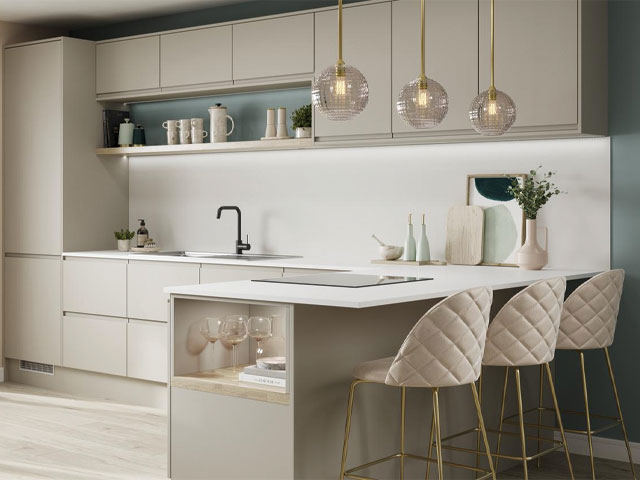 kitchen peninsula in a neutral handless kitchen with blush pink bar stools