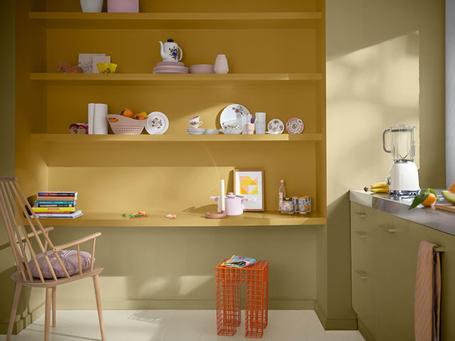 kitchen with open shelves painted in pale yellows and greens