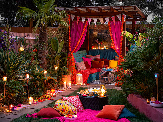 outdoor garden party with colourful textiles, garden lights and pergola