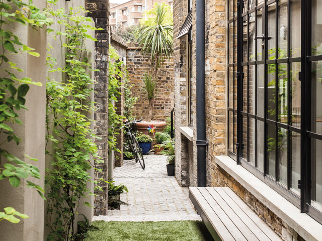 courtyard garden of a converted victorian warehouse in whitechapel, east london