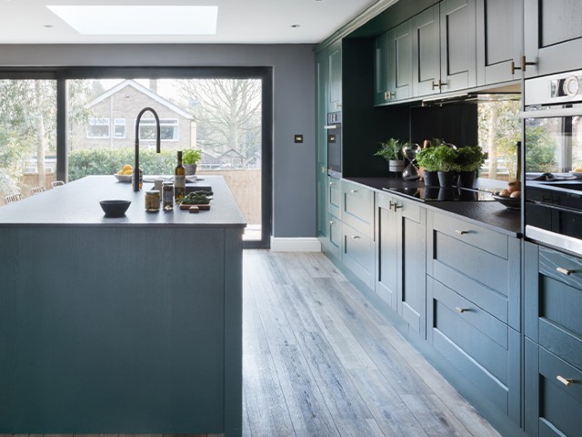 rear extension with dark wooden floor, large sliding windows/doors and dark cabinetry