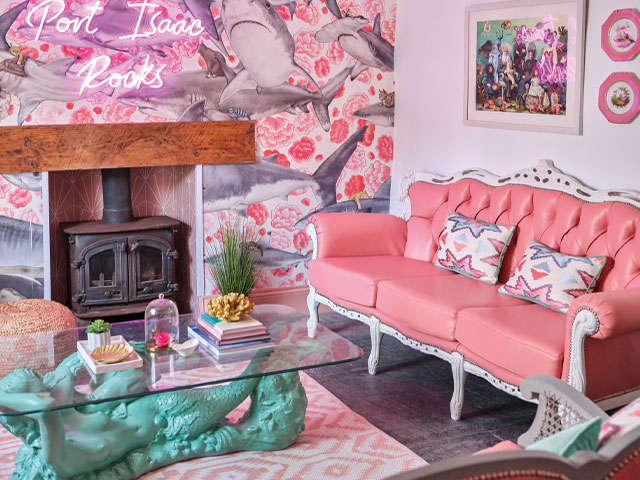 pink lounge with shark print wallpaper, bridgerton pink sofa and mermaid coffee table