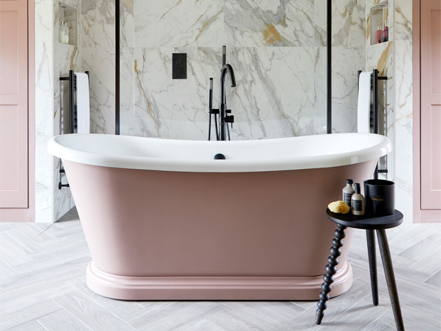 pink freestanding bath in large bathroom with marble tiles and walk-in shower