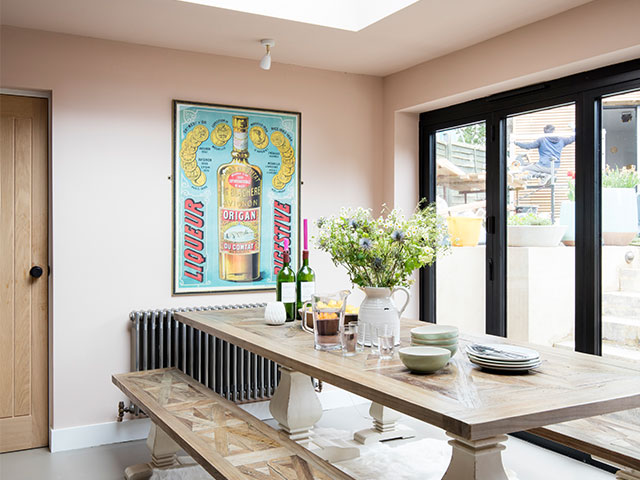 The contemporary wooden table with benches echoes the oak units