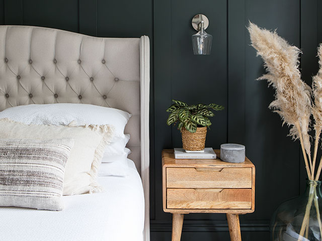 modern bedroom in a renovated 1930s house with green panelled walls