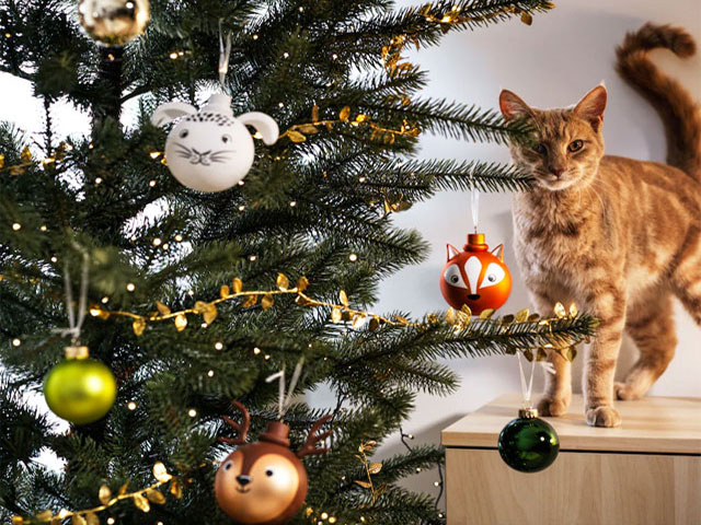 ikea christmas tree with cute baubles and a cat in the background