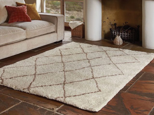 neutral Berber rug on a natural wooden floor in a traditional living room
