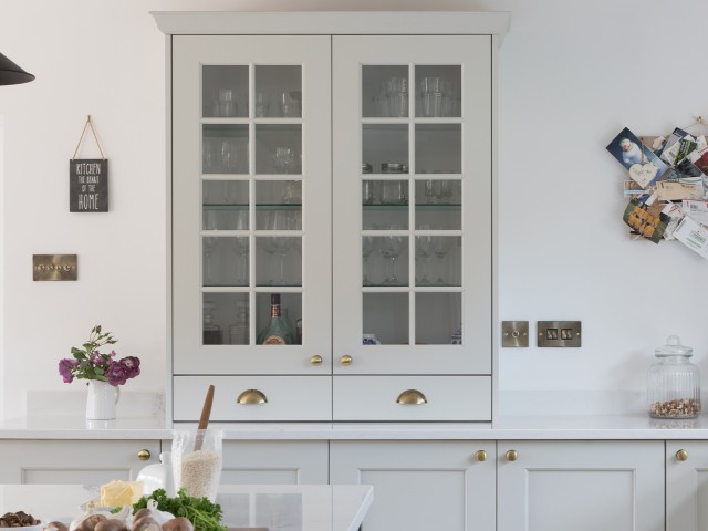 white-painted bespoke drinks cabinet displaying glassware