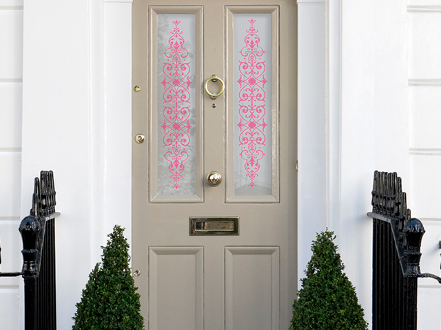 pink patterned window film on a festive front door