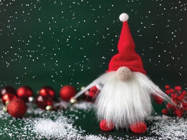 christmas gonk on a green background with snow and red baubles