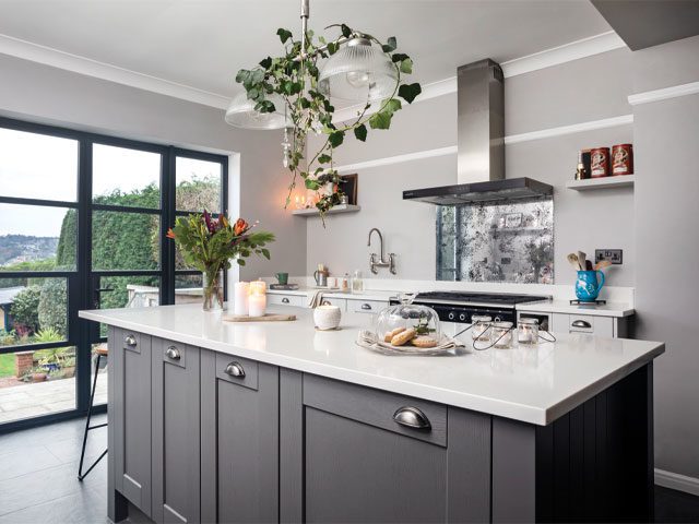 modern kitchen with large island and grey cabinets in a 1930s period house