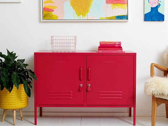 pink locker sideboard in a modern home with colourful artwork on the wall