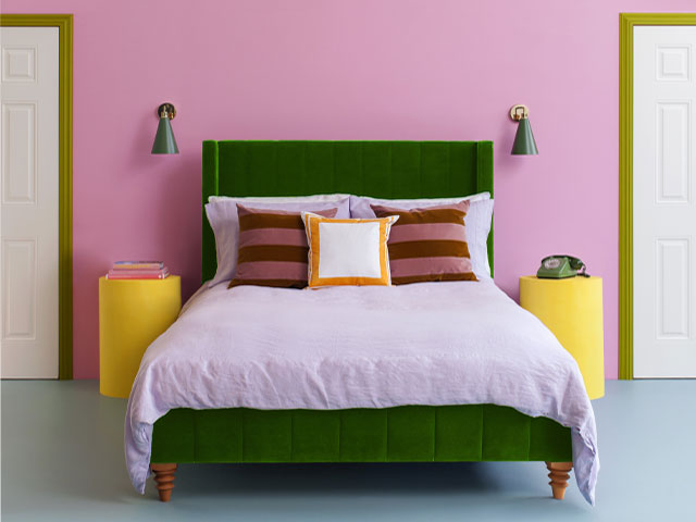 Dopamine decor bright paint colours in a bedroom with green velvet bed