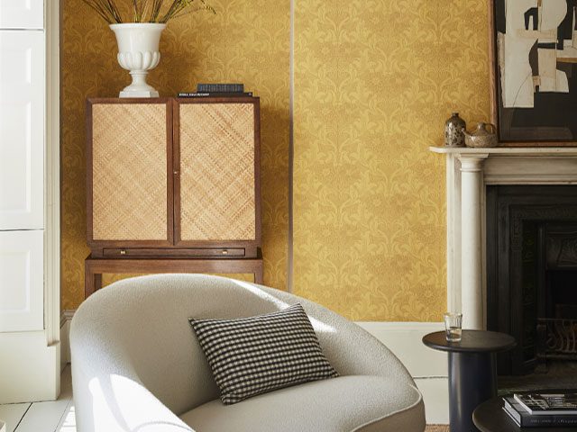living room with yellow-gold walls, vintage cabinet, original fireplace and curved, boucle sofa in white