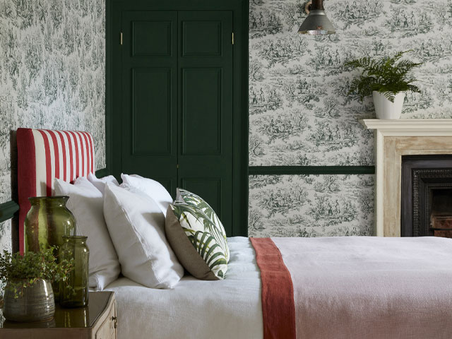 Little Greene x National Trust Wallpaper in a bedroom with green door and plants
