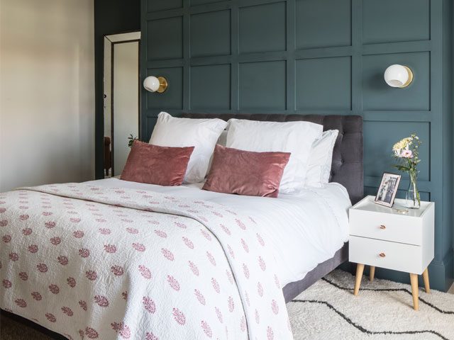 bedroom with deep blue/green painted wall