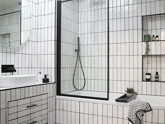 black and white bathroom with white metro tiles laid vertically