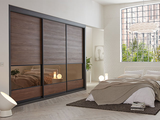 sliding wardrobe doors in English walnut in a bedroom in a warehouse conversion 