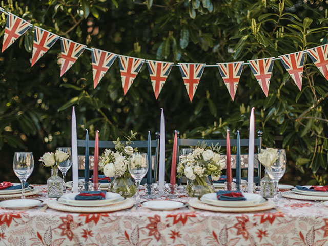royalcore table decor with bunting and red white and blue candles