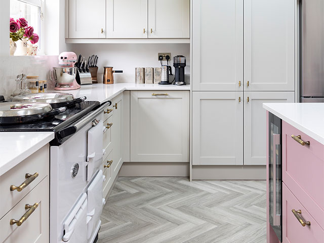 A mix of cream and pink cabinetry works in the spacious kitchen