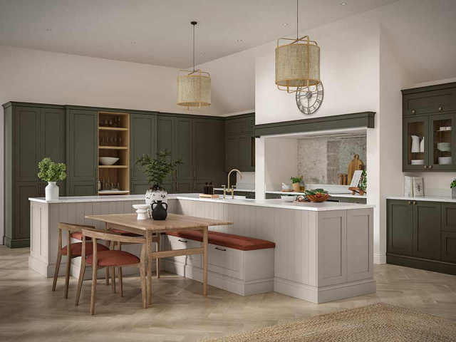 slim shaker kitchen with green cabinets and a dove grey kitchen island with dining table and built-in banquet