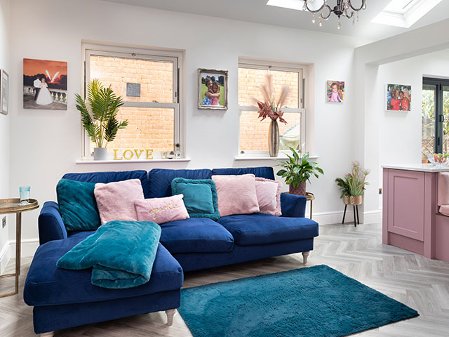 A colourful spacious and sociable kitchen with a pink and teal colour scheme