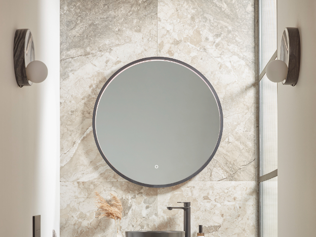 An illuminated mirror adds a chic look to a small bathroom