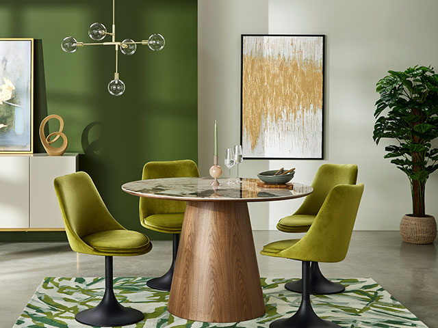 Round glass table in green living room with green decor