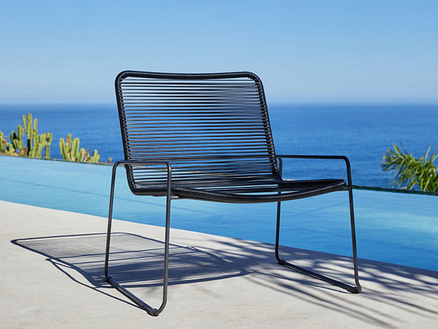 Black sleek garden armchair on poolside