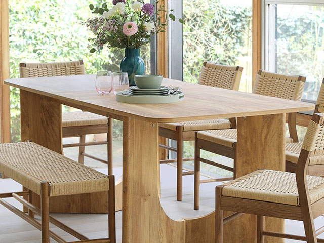 Wooden large table with bench seating in conservatory space