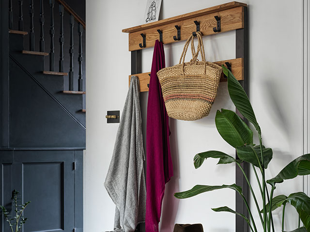 Bags and coats hanging on hooks in hallway