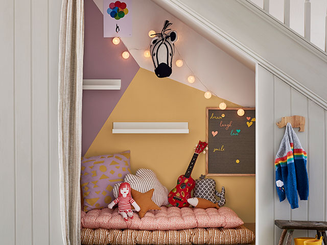 Childrens den with fairy lights in under stairs part of hallway